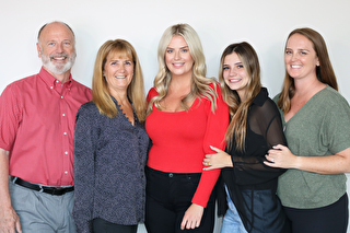 Group of five people smiling together