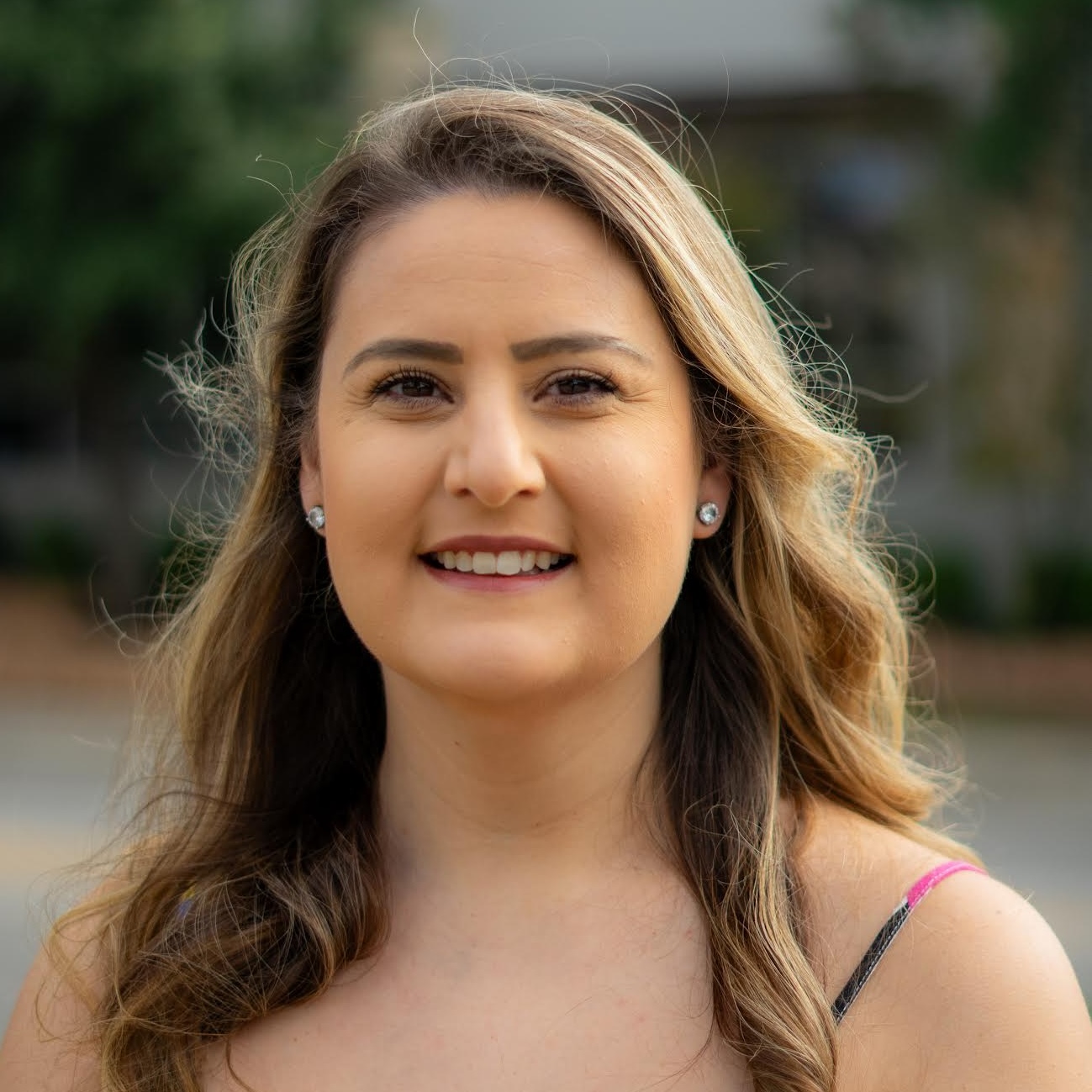 front office amber Smiling woman outdoors with blurred background