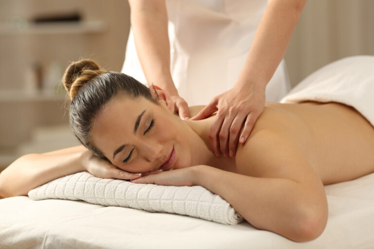 Woman enjoying a relaxing back massage at spa.
