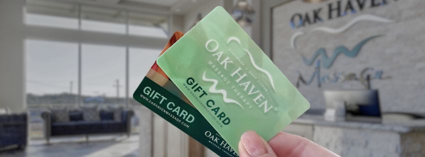 Oak Haven gift cards in hand, spa lobby background.